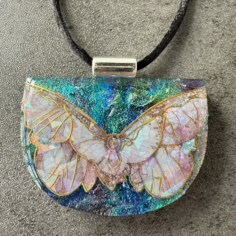 Butterfly pendant necklace on a textured surface