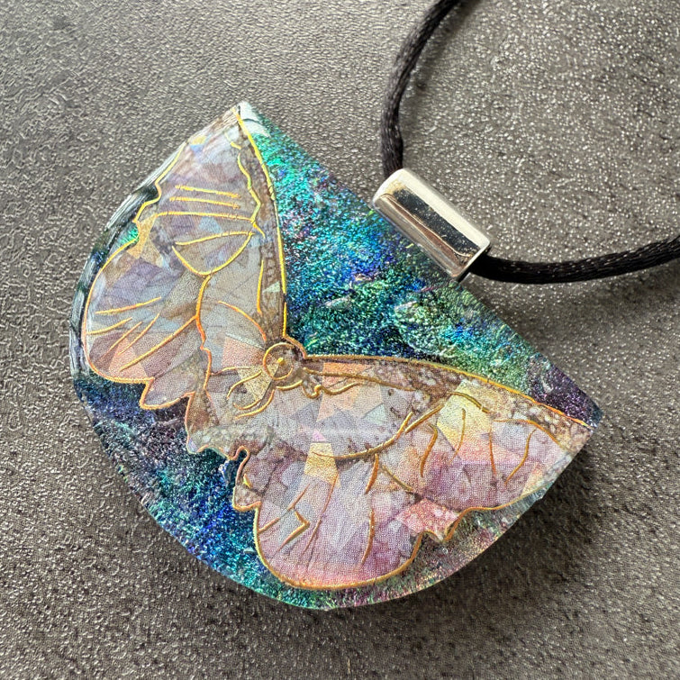 Butterfly pendant necklace on a textured surface