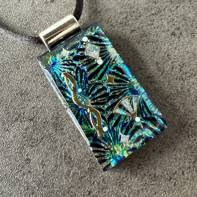 Decorative pendant with floral patterns on a textured surface