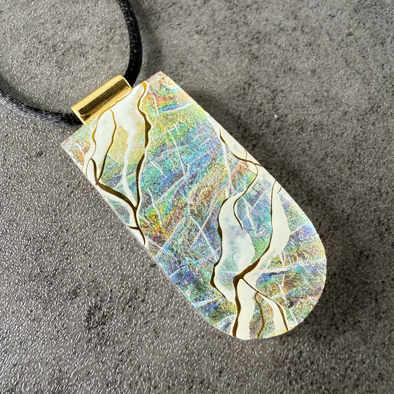 Marbled pendant necklace on a textured surface