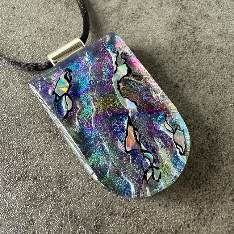 Colorful pendant with abstract design on a neutral background