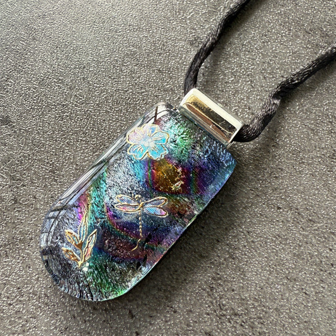 Colorful pendant with floral designs on a textured surface