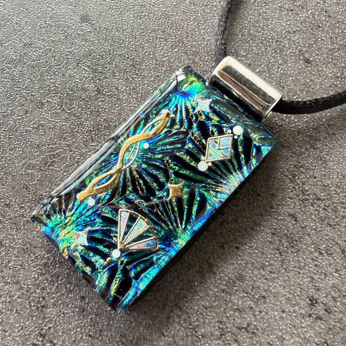 Decorative pendant with intricate design on a gray surface