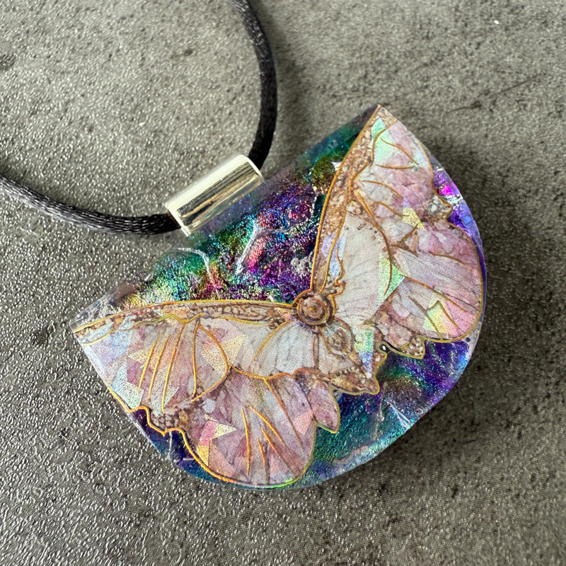 Butterfly pendant on a textured surface