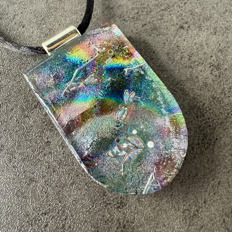 Holographic pendant with butterfly design on a textured surface